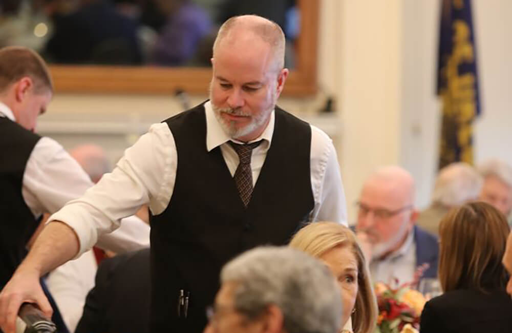 Waiter pouring drinks